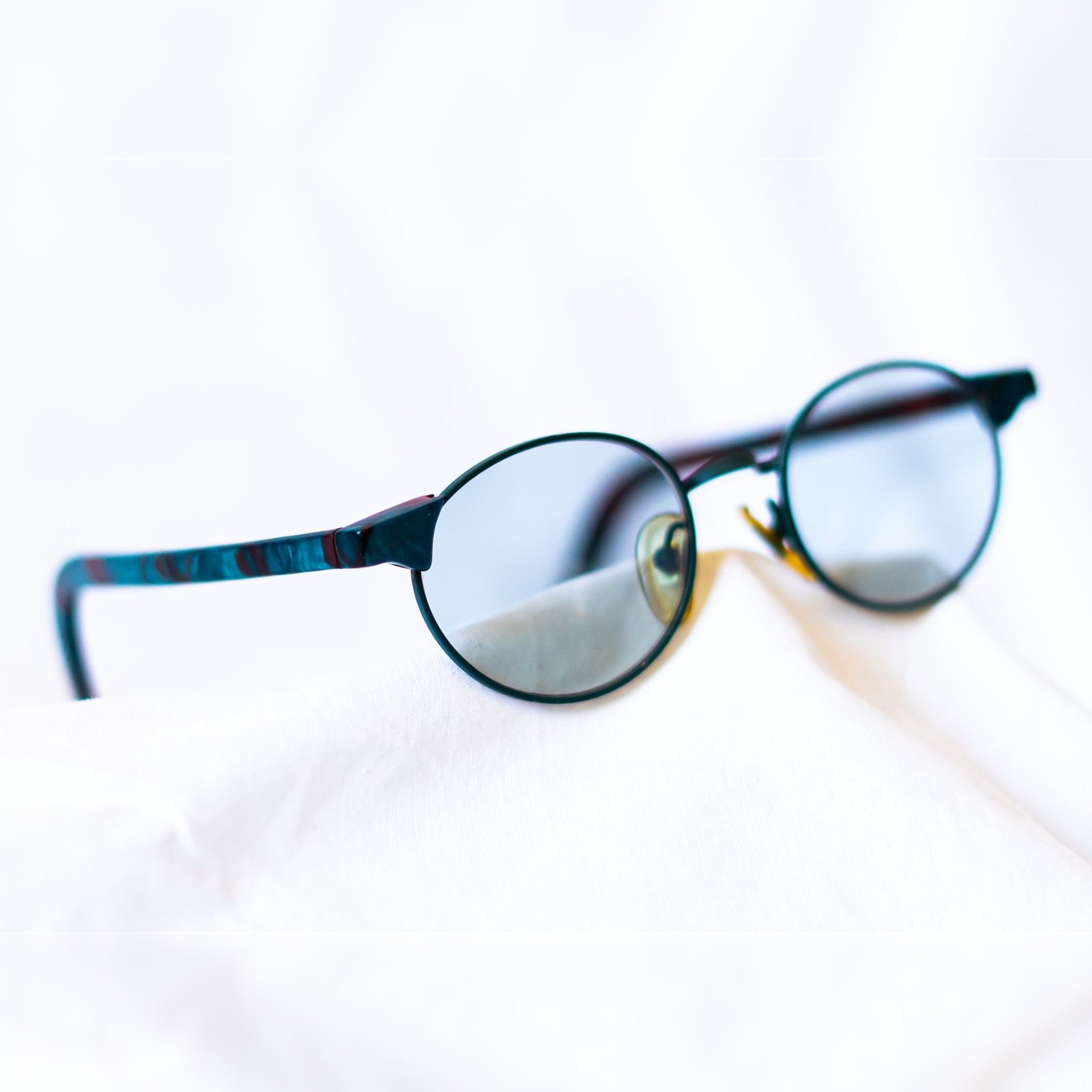 LAGOON Sunglasses - lifestyle angled view on white fabric